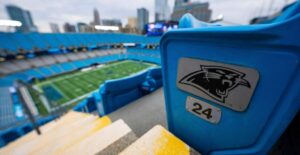 A close-up shot of a seat looking onto the football field at Bank of American Stadium