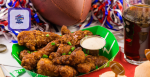 A plate of wings and a football signifying the best Super Bowl watch parties in Wilmington